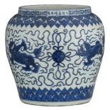 A large Chinese blue and white cachepot, decorated with playing kylins and flower petals, with a