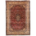 An Oriental rug, wool and silk on cotton, decorated with floral motifs and a central medallion,