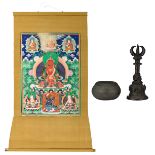 A Tibetan thangka, gouache on textile, 20thC, 83 x 137 cm; added a bronze ritual bell, 19th/20thC;