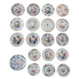 A lot of twelve Chinese Imari dishes, decorated with landscapes, flowers and the pierced scholar's