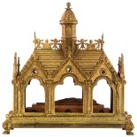 A gilt brass Gothic Revival shrine with a wooden figure within and several fragments of relics, H