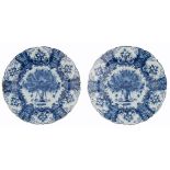 Two fine Delftware plates with a fluted rim, decorated in the centre and the roundels with flower