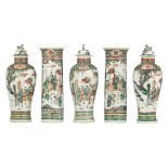 A Chinese famille verte five piece cabinet garniture, decorated with a continuous scene with high