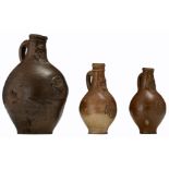 A lot of three Cologne stoneware bellarmine jugs, 16th/17thC, the body of all three moulded with