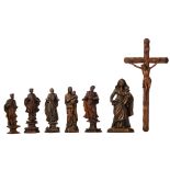 A lot of seven religious wooden sculptures, consisting a crucifix, two Holy Mother and childs and