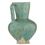 A turquoise glazed epigraphic Seljuk jug with engraved decoration, Persia, ca. 1200, repaired, H