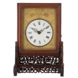 A Chinese gilt bronze table clock in a sculpted rosewood frame, horror vacui decorated with