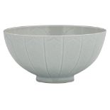 A Chinese relief decorated white glazed 'lotus' bowl with incised lotus flower design, the