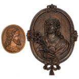 A large oval-shaped oak basso-relievo depicting Saint Joseph holding a lily, 18thC; added an oval-