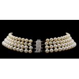 A four strand cultured pearl 'ras du cou' necklace with a 835/000 silver extender, length 34,5 cm (
