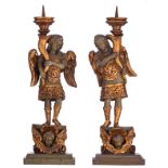 A pair of gilt and polychrome painted wooden church altar candelabras shaped like angels, 17th/