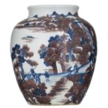 A blue and white and copper red jar in the Ming style decorated with travellers in a mountainous