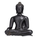 A South East Asian bronze seated figure, depicting a Buddha, with black lacquer patina, on a