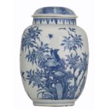 A blue and white covered pot decorated with birds sitting on flower branches and flying insects,