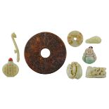 A lot of seven items in green jade, consisting of a snuff bottle, a hanger and other small