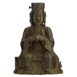 A Chinese Ming style bronze figure of a seated dignitary holding a sceptre, H 41,5 cm