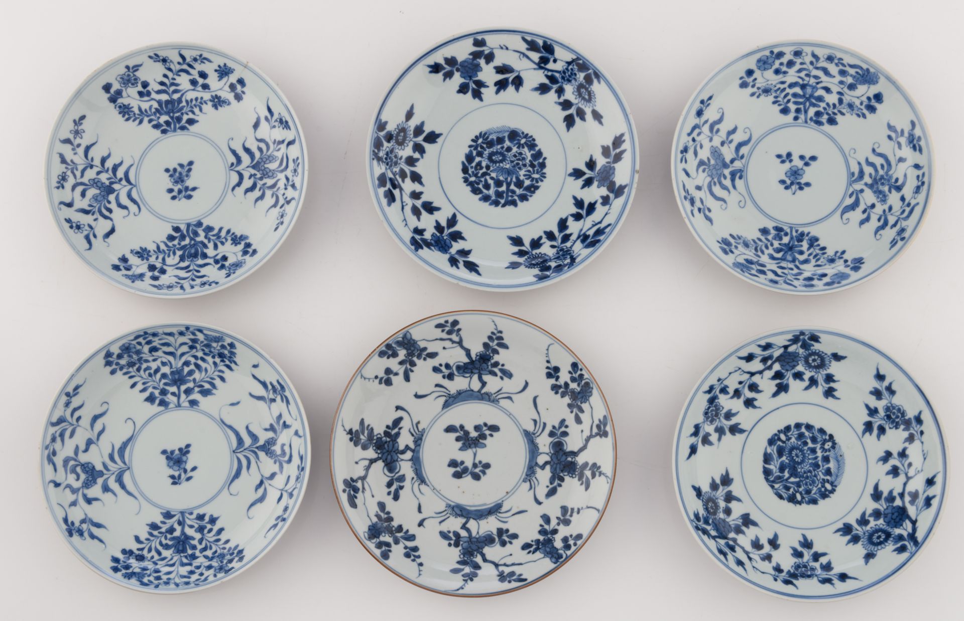 Nine Chinese underglaze-blue decorated café-au-lait glazed dishes with various flower designs; - Image 10 of 15