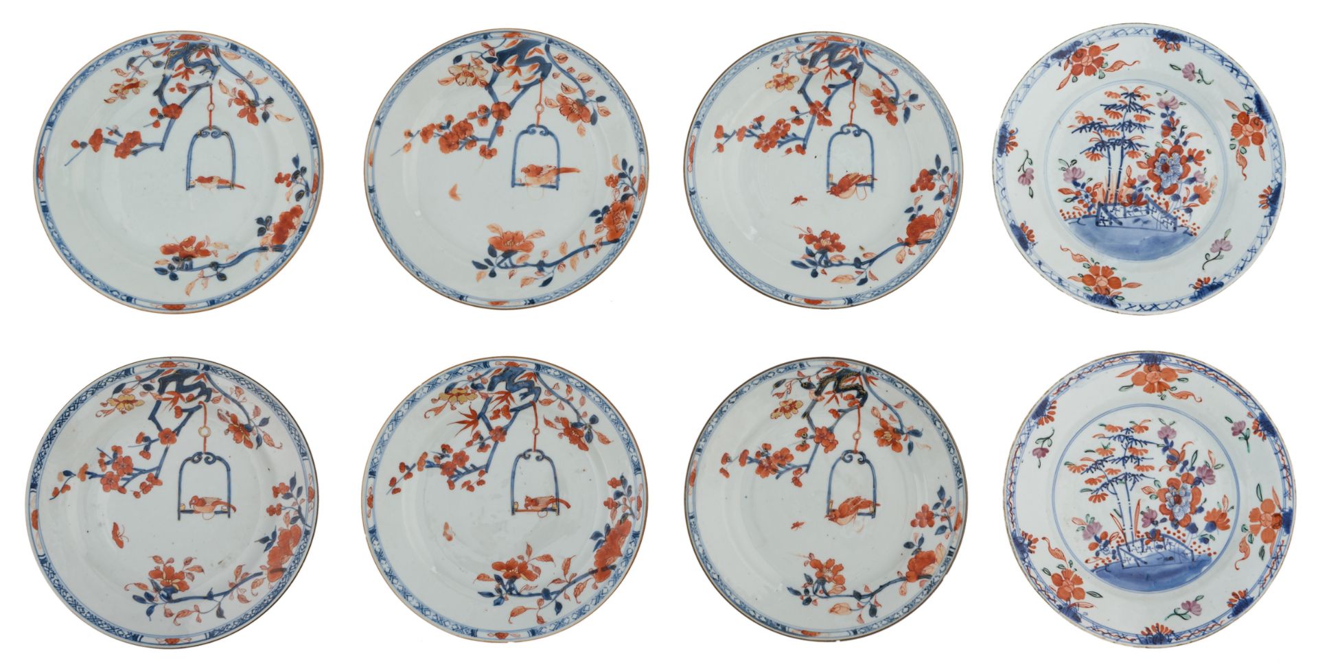 Six Chinese Imari dishes, decorated with a parrot on a swing and flower branches; added: a ditto