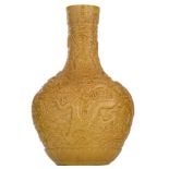 A Chinese mustard-yellow glazed bottle vase, relief decorated with the five-clawed dragon amidst