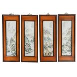 Four framed Chinese polychrome decorated porcelain plaques, depicting figures in a mountainous