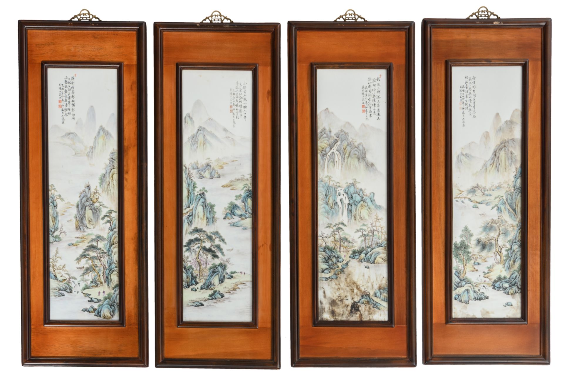 Four framed Chinese polychrome decorated porcelain plaques, depicting figures in a mountainous