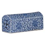 A Chinese blue and white porcelain arm rest, decorated with lotus scrolls and leafy tendrils in