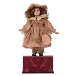 A late 19thC French mechanical musical dancing doll, with an original wig and lace decorated