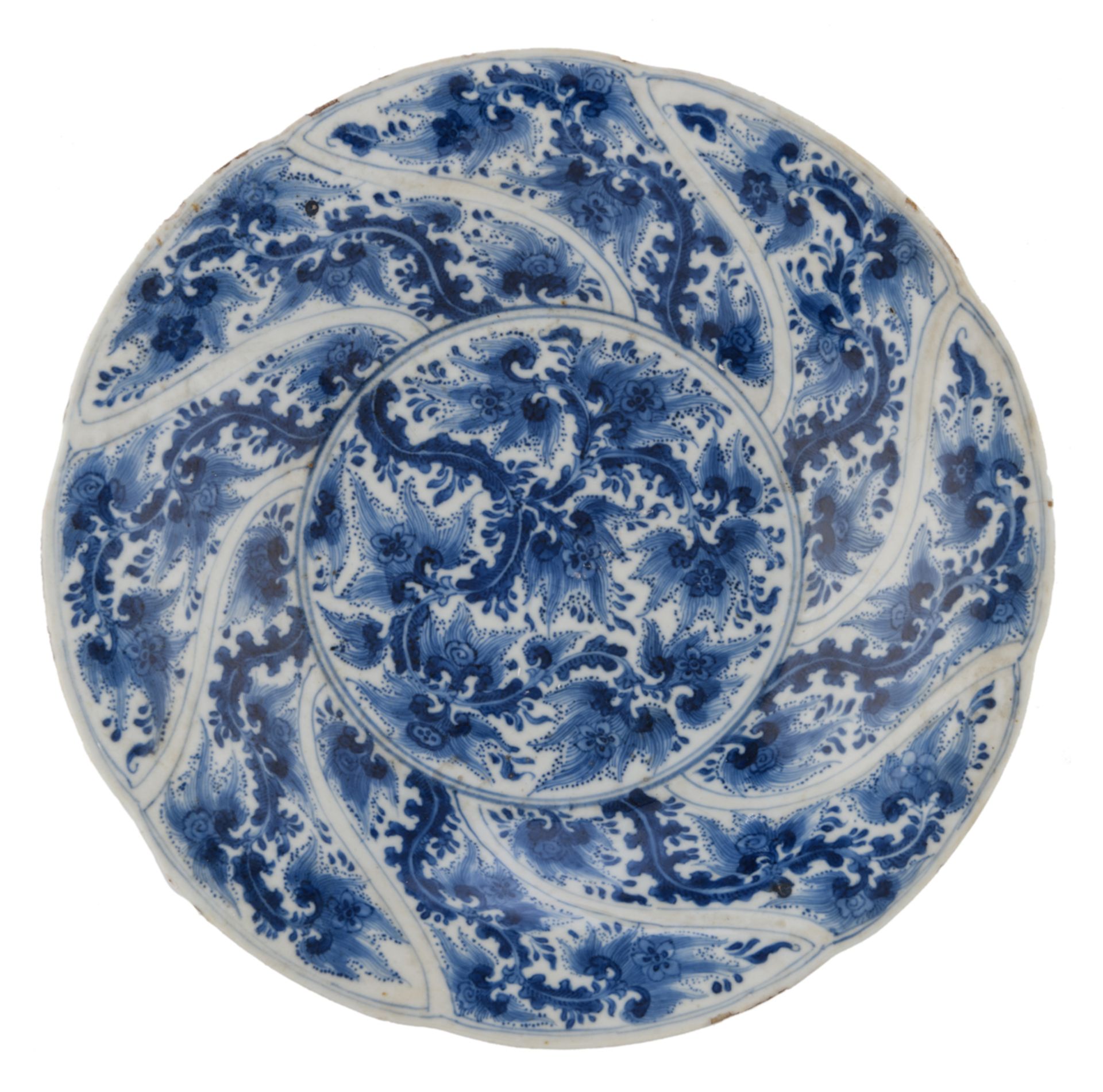 A Chinese Kangxi blue and white export porcelain soup plate, the well decorated with leafy