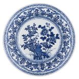 A Chinese blue and white charger, the centre decorated with a scholar's rock and peonies and
