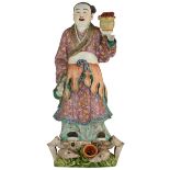 A Chinese polychrome decorated porcelain figure, depicting a girl, standing on a crab, symbolising