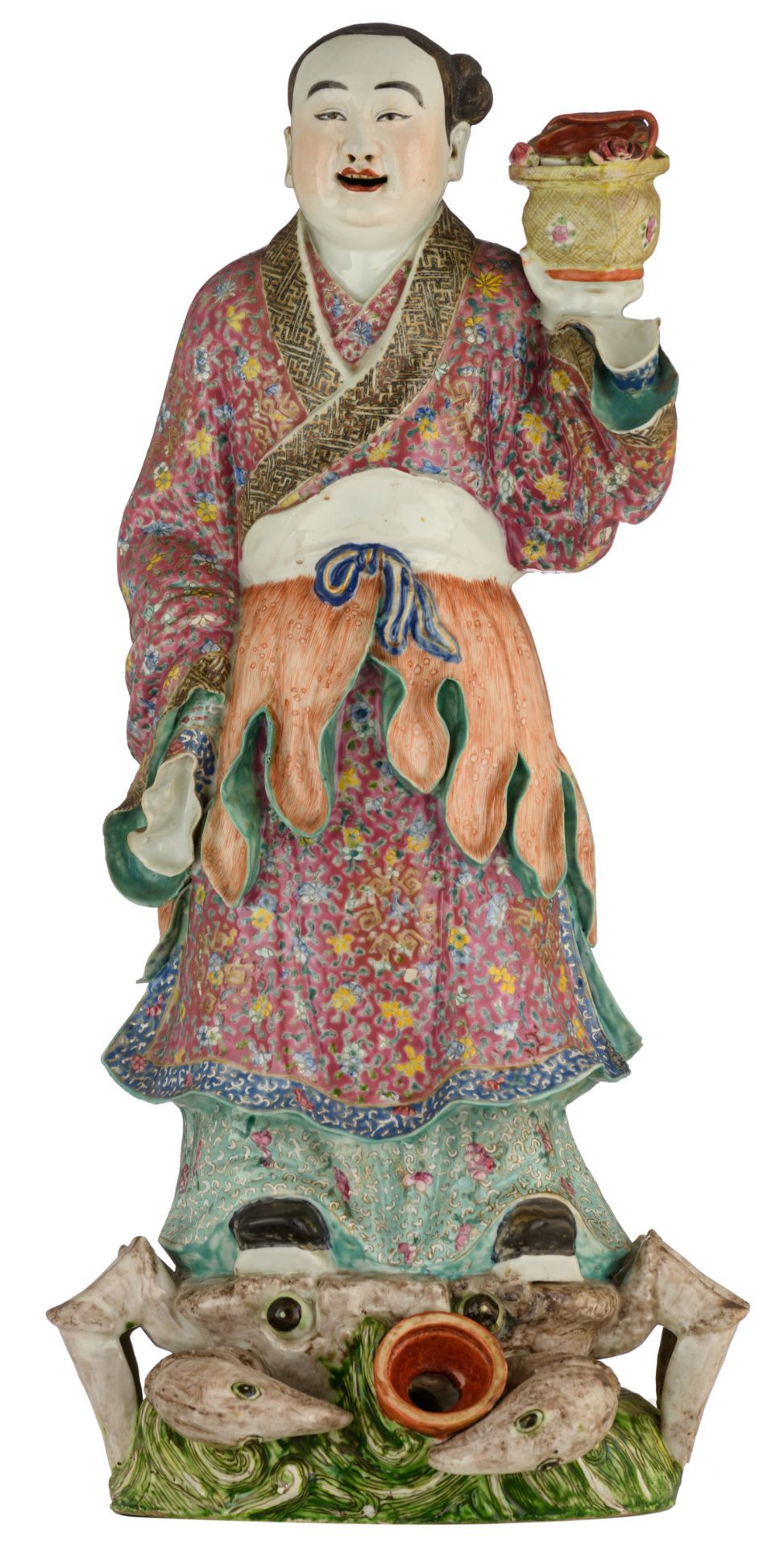 A Chinese polychrome decorated porcelain figure, depicting a girl, standing on a crab, symbolising