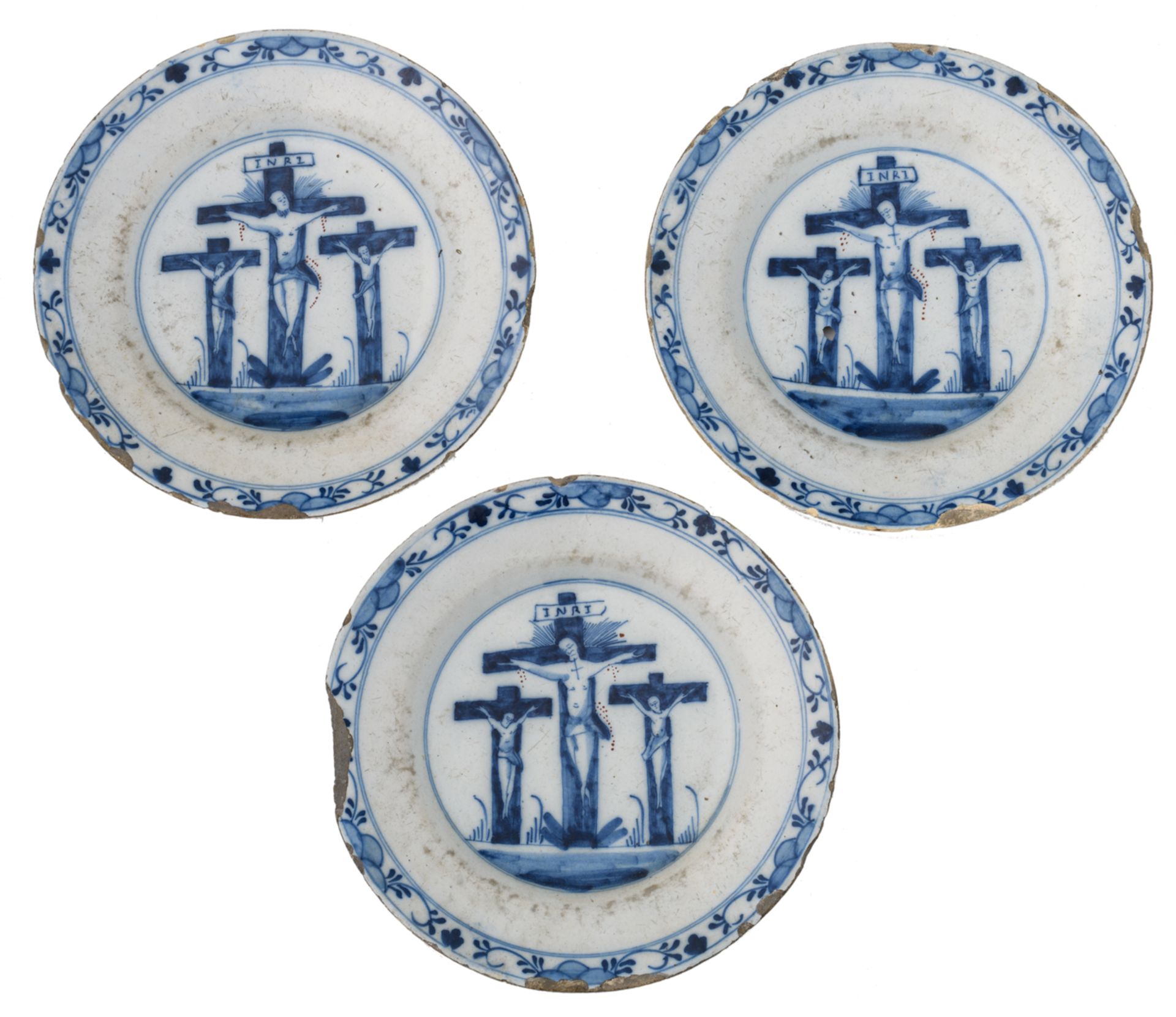 Three late 17th - early 18thC Dutch Delftware plates blue and white decorated with a Calvary, 23 ø