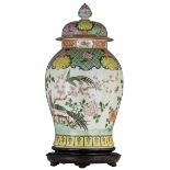An imposing Chinese famille rose vase and cover, decorated with phoenix in a garden setting, the