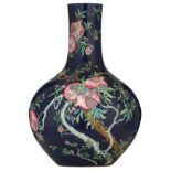 A Chinese blue ground famille rose tianqiuping, decorated with blossoming pomegranate tree branches,
