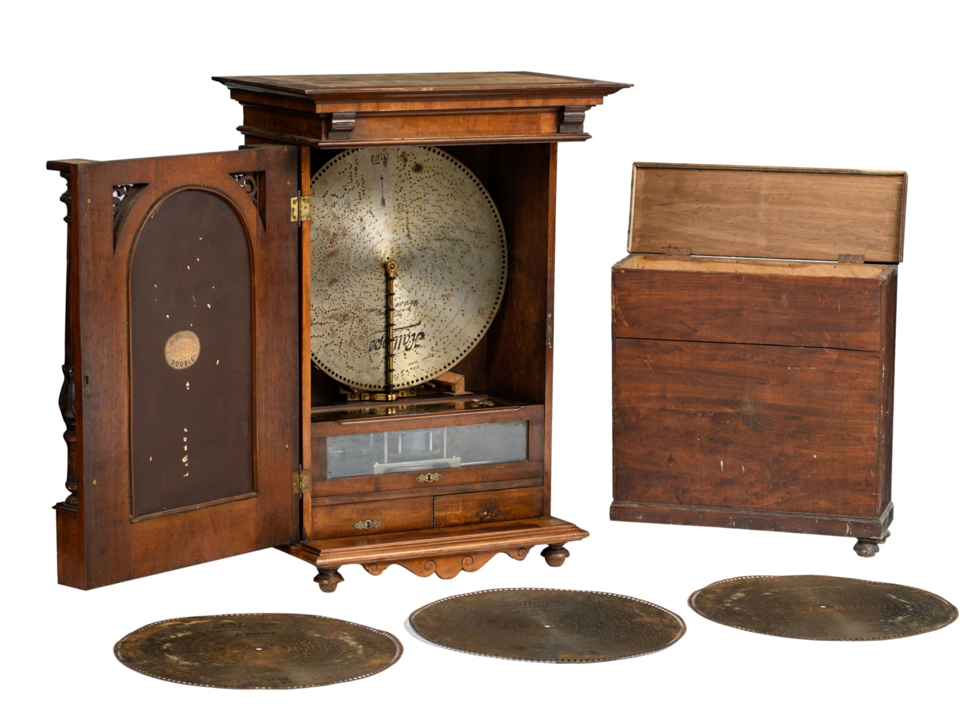 A Renaissance revival walnut hanging Polyphon-type music-box, the door with a chamfered edge mirror,