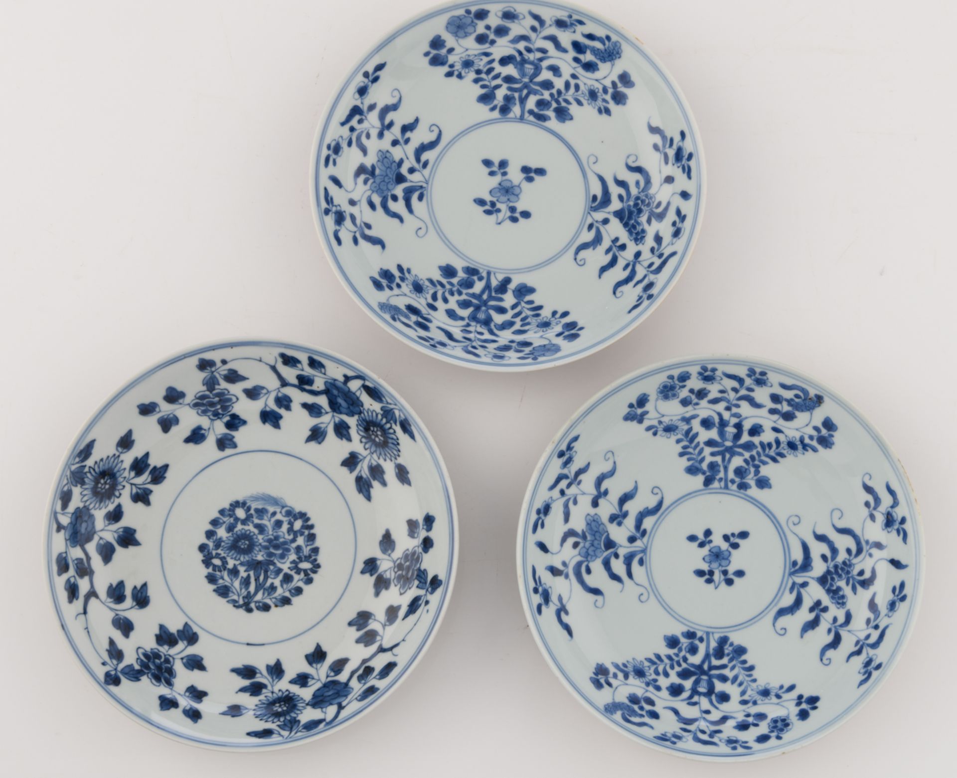 Nine Chinese underglaze-blue decorated café-au-lait glazed dishes with various flower designs; - Image 12 of 15