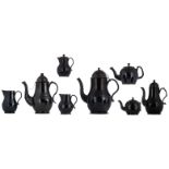 A collection of eight black glazed Namurois earthenware items consisting of: three coffee pots,