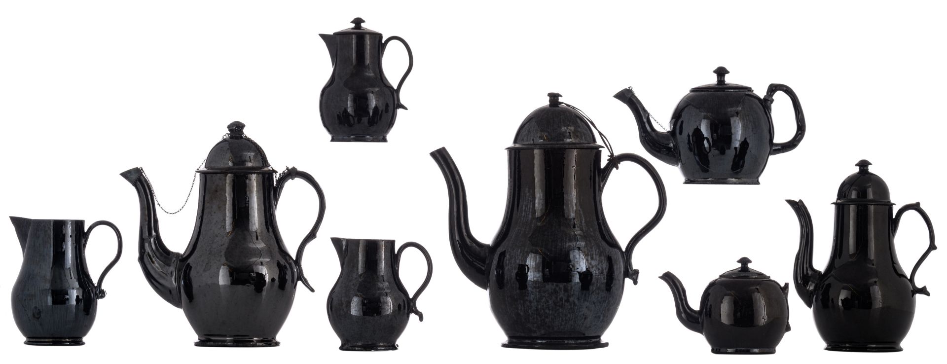 A collection of eight black glazed Namurois earthenware items consisting of: three coffee pots,