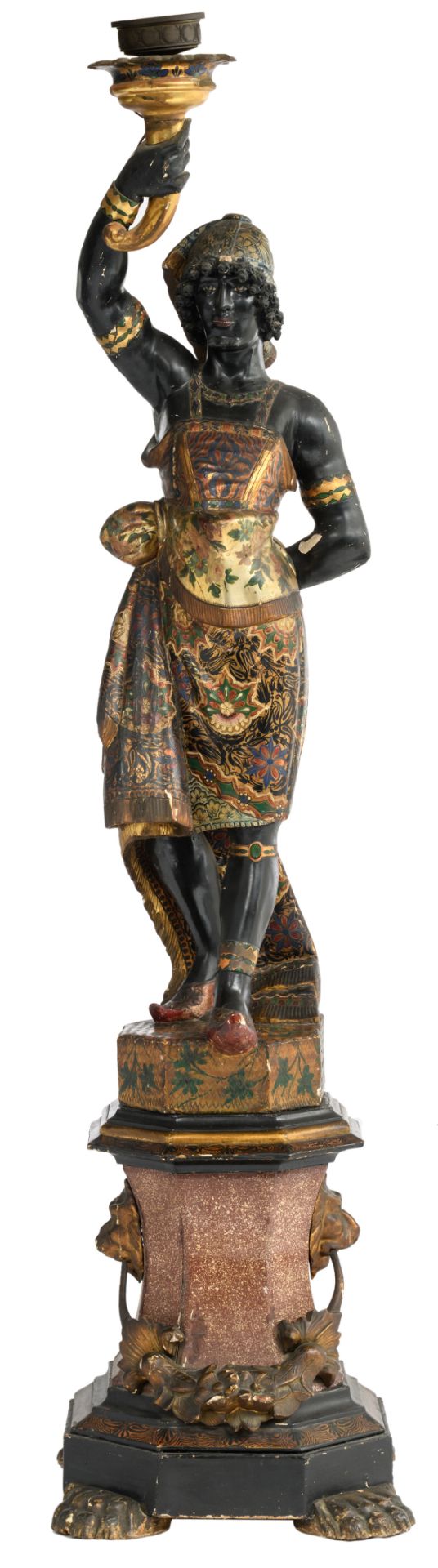 A probably Venetian polychrome painted and giltwood blackamoor torchère modeled holding a single