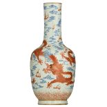 A Chinese polychrome decorated porcelain bottle vase, with the five-clawed dragons in iron red,