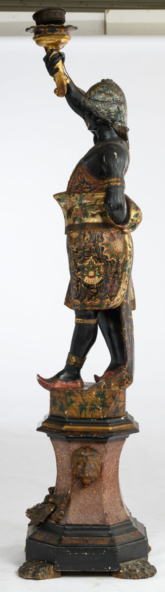 A probably Venetian polychrome painted and giltwood blackamoor torchère modeled holding a single - Image 2 of 4