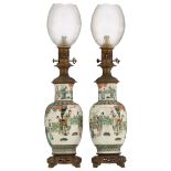 A pair of Chinese famille verte vases, decorated with beauties, playing music in a garden, mounted