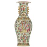 A Chinese Canton famille rose vase, decorated with various fruits, Buddhist symbols, flowers and