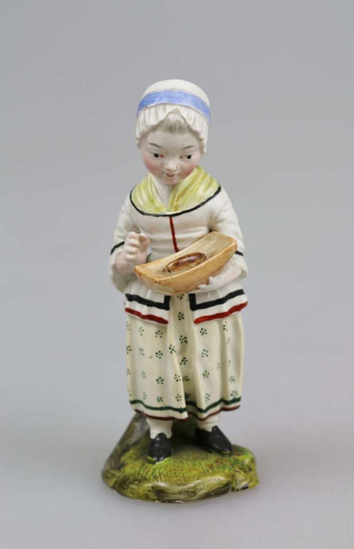 Höchst, Porzellanfigur "Mädchen mit Brot" um 1780, in der linken Hand einen Brotlaib haltend, auf