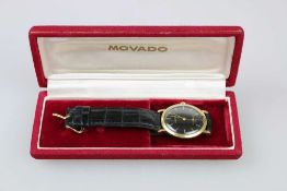 Movado Herrenarmbanduhr, Schweiz um 1950, Handaufzug, schwarzes Ziffernblatt mit goldenen Zeigern,