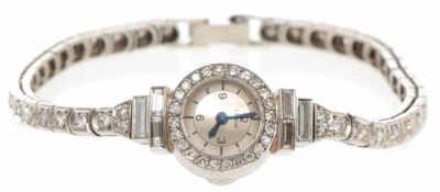 Schmuck-Armbanduhr750/-WG, E. Gübelin, 1950er Jahre Zarte Uhr, kompl. besetzt m. Diamanten im