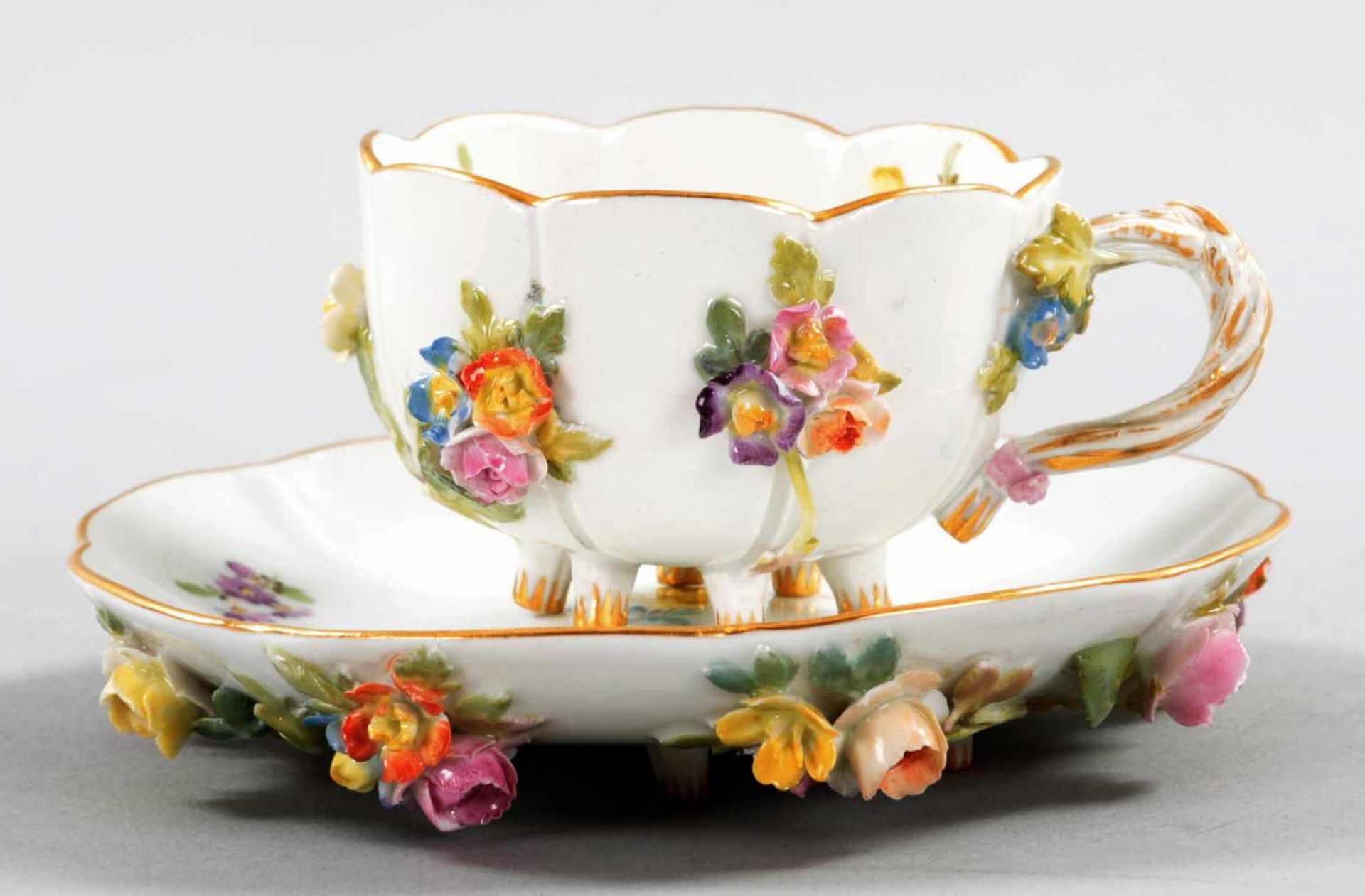 Kl. ZiertassePorzellan, Meissen, 19.Jh. Je auf kl. Astfüßen die Tasse u. Unterschale m.