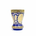 Böhmisches Glas20. Jh., Glas, farbig und gold staffiert, mit umlaufendem Blumendekor und Goldrand,