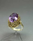 RING, besetzt mit ovalem, geschliffenem Amethysten in durchbrochener 585er Gelbgoldfassung (6 g);