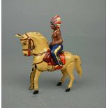 BLECHSPIELZEUG / SPIELFIGUR: Indianer auf Pferd / indian toy figure with a horse, Mitte 20. Jh.,